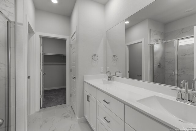 bathroom featuring vanity and an enclosed shower