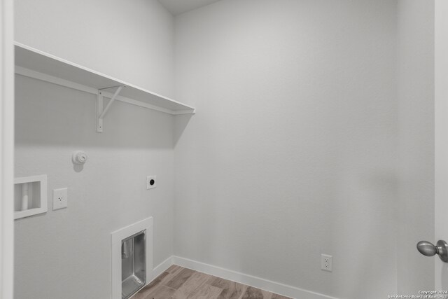 laundry room with hookup for a gas dryer, hookup for an electric dryer, and light hardwood / wood-style floors