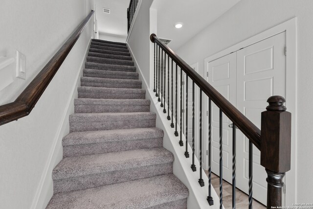 stairs with wood-type flooring