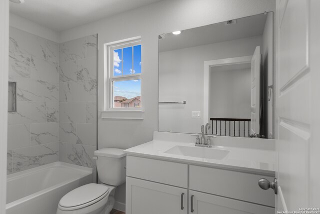 full bathroom with tiled shower / bath combo, vanity, and toilet