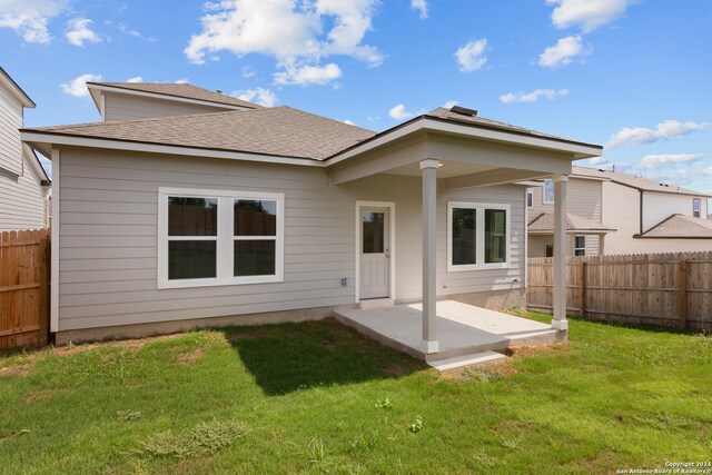 back of property featuring a lawn and a patio area