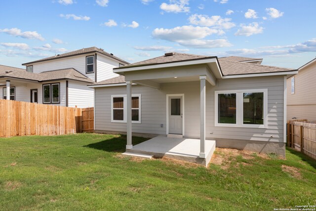 back of house featuring a yard and a patio