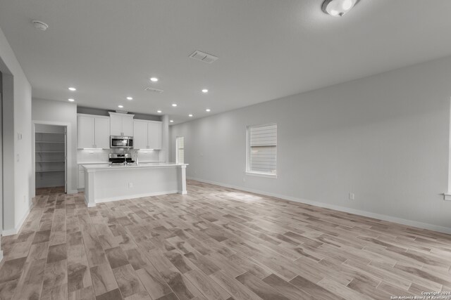 unfurnished living room featuring light wood-type flooring