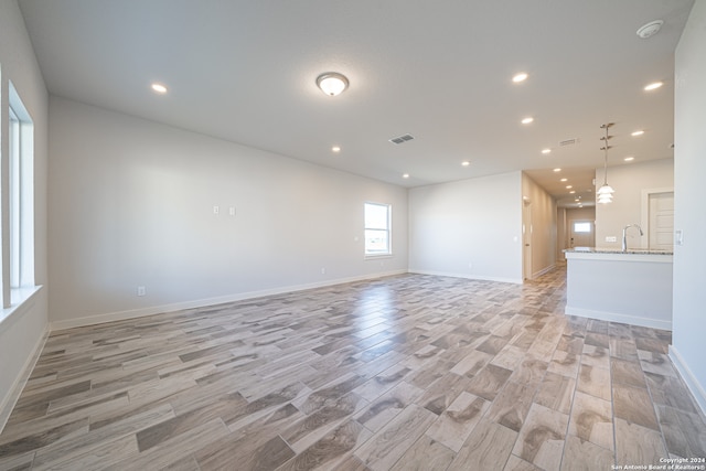 empty room with light hardwood / wood-style flooring