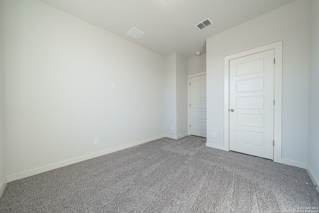 unfurnished bedroom with a closet and carpet