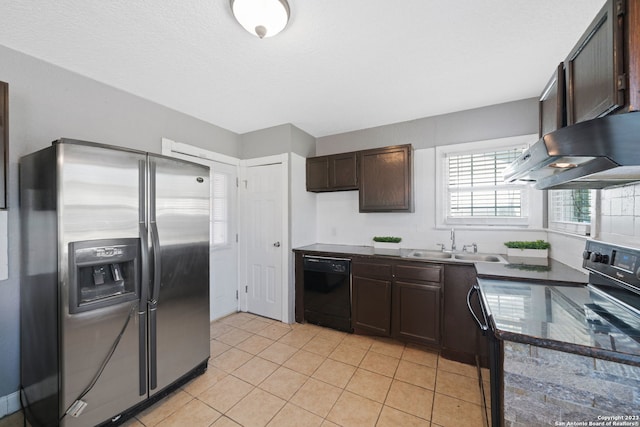 kitchen featuring dark brown cabinets, dark stone countertops, sink, black appliances, and light tile patterned floors