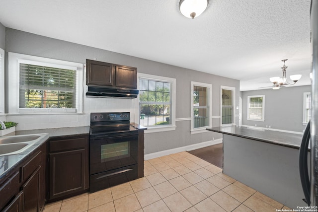 kitchen featuring plenty of natural light, sink, light tile patterned floors, and black electric range