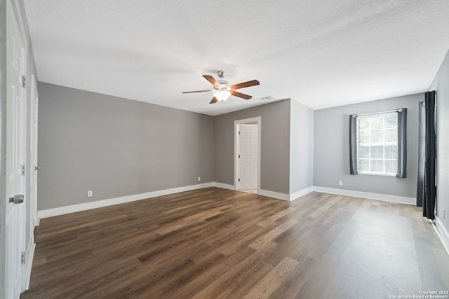 unfurnished bedroom with ceiling fan, dark wood-type flooring, and a textured ceiling