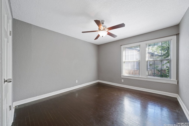 unfurnished room featuring ceiling fan, dark hardwood / wood-style floors, and a textured ceiling