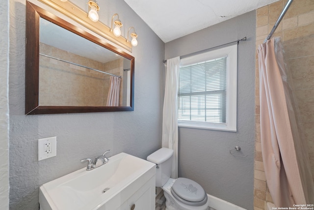 bathroom featuring vanity, toilet, and a shower with shower curtain