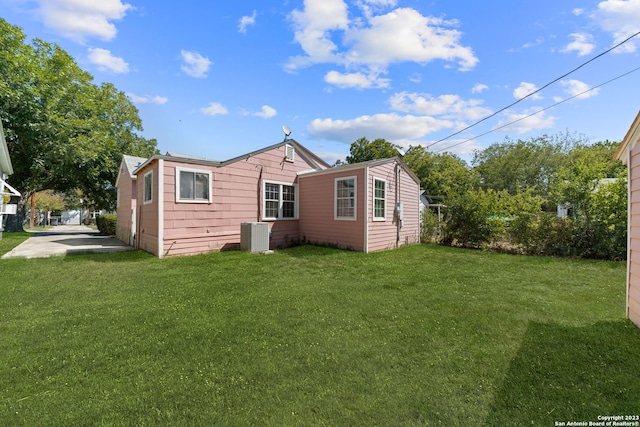 rear view of property with a yard