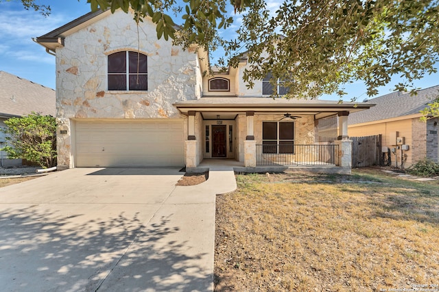 view of front of house featuring a front yard, a garage, a porch, and ceiling fan