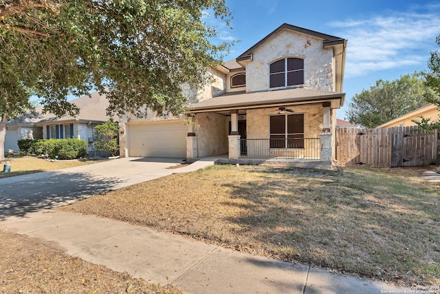 235 Hondo Dr, New Braunfels, TX 78130 - view of front of house featuring stone siding, covered porch, concrete driveway, a ceiling fan, and a garage