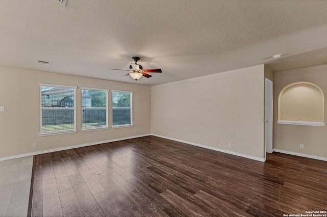 235 Hondo Dr, New Braunfels, TX 78130 - unfurnished room featuring a ceiling fan, dark wood-style flooring, a textured ceiling, and baseboards