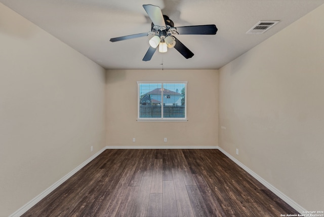 unfurnished room with ceiling fan and dark hardwood / wood-style flooring