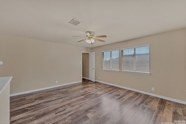 empty room featuring hardwood / wood-style flooring and ceiling fan