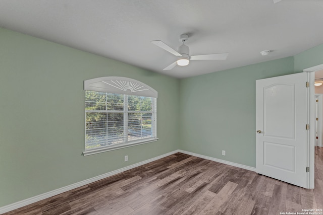 empty room with hardwood / wood-style flooring and ceiling fan