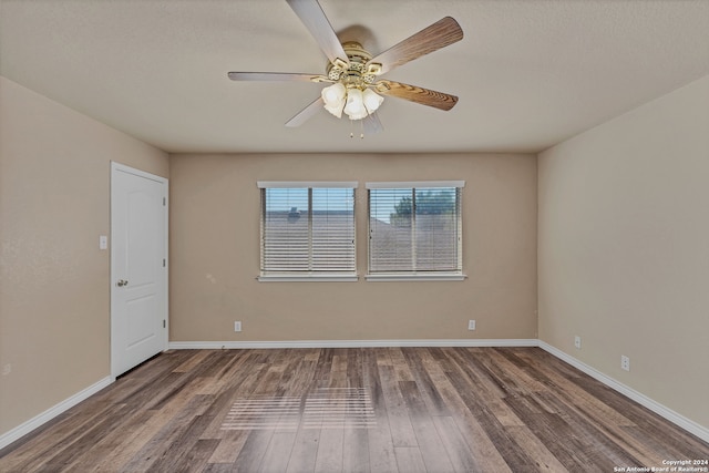 spare room featuring hardwood / wood-style floors and ceiling fan