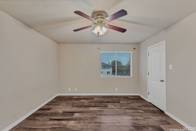 unfurnished room featuring ceiling fan and dark hardwood / wood-style flooring