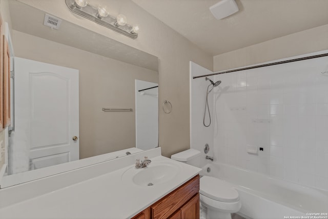 full bathroom with toilet, vanity, and tiled shower / bath combo