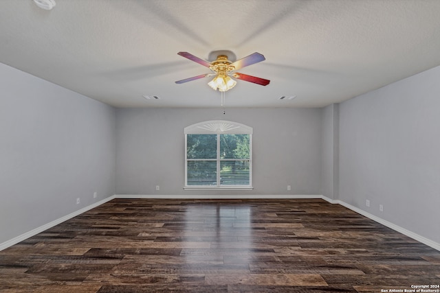 unfurnished room featuring ceiling fan, a textured ceiling, and dark wood-type flooring