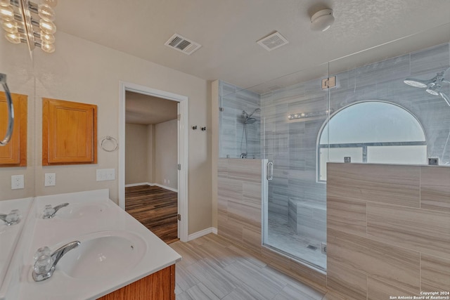 235 Hondo Dr, New Braunfels, TX 78130 - bathroom with a stall shower, double vanity, and baseboards