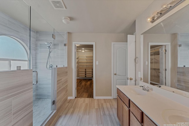 235 Hondo Dr, New Braunfels, TX 78130 - full bath featuring a shower stall, baseboards, double vanity, and a walk in closet