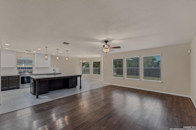 235 Hondo Dr, New Braunfels, TX 78130 - kitchen featuring stainless steel range with electric stovetop, a sink, open floor plan, a ceiling fan, and healthy amount of natural light