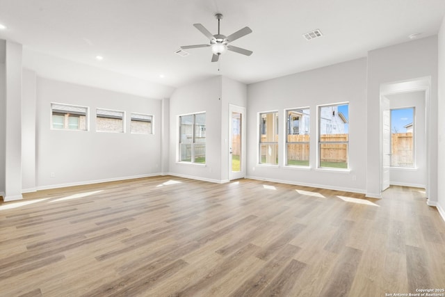 unfurnished living room featuring light wood-type flooring, vaulted ceiling, and ceiling fan