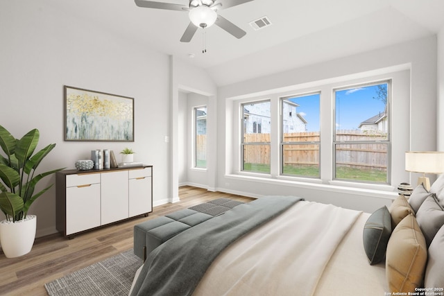 bedroom featuring hardwood / wood-style floors, ceiling fan, and lofted ceiling