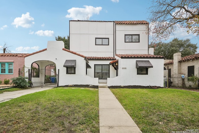 mediterranean / spanish-style house featuring a front lawn