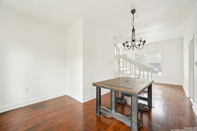 dining space with a chandelier and dark hardwood / wood-style floors