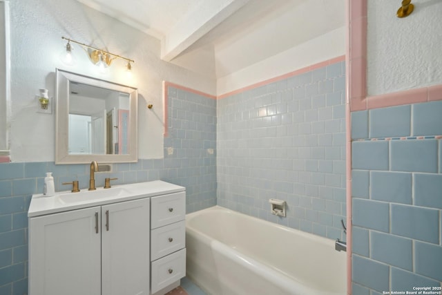 bathroom with vanity and tile walls