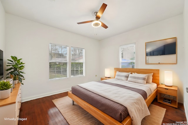 bedroom featuring ceiling fan and dark wood-type flooring