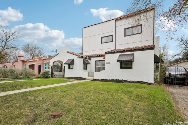 mediterranean / spanish house featuring a front lawn