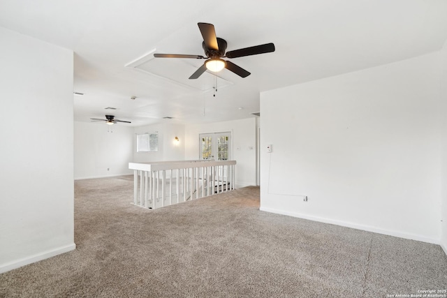 carpeted empty room featuring ceiling fan