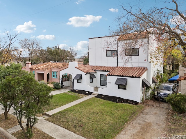 mediterranean / spanish-style house featuring a front yard