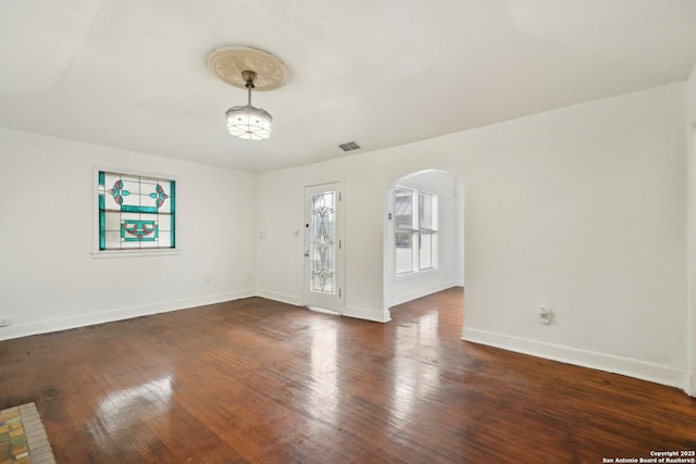 empty room with dark wood-type flooring