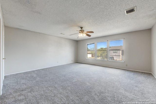 carpeted empty room featuring a textured ceiling and ceiling fan