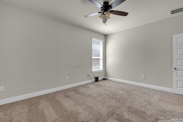 empty room featuring ceiling fan and carpet floors