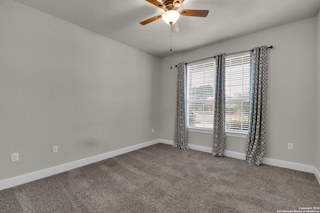 carpeted empty room with ceiling fan and a textured ceiling