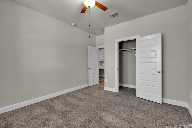 unfurnished bedroom with ceiling fan, a closet, carpet floors, and a textured ceiling