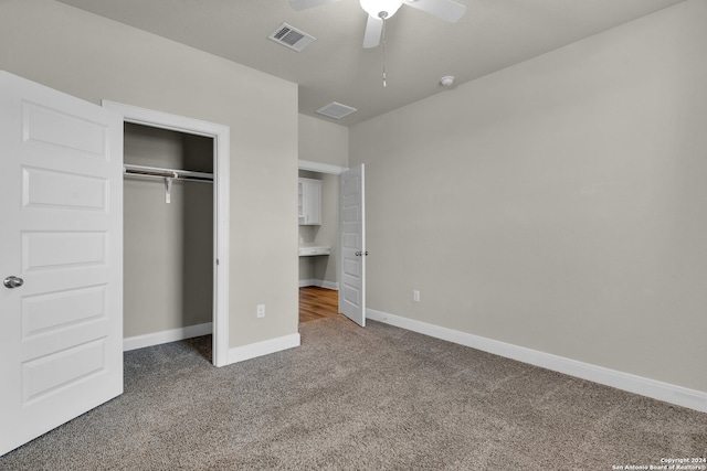 unfurnished bedroom featuring carpet, a closet, and ceiling fan