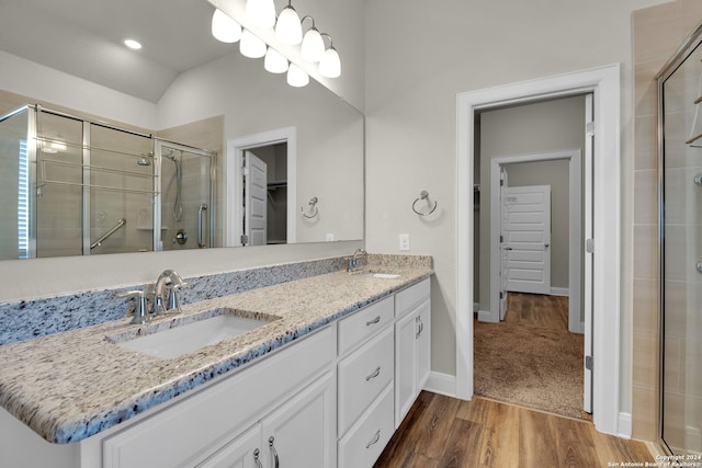 bathroom featuring vanity, an enclosed shower, lofted ceiling, and hardwood / wood-style flooring