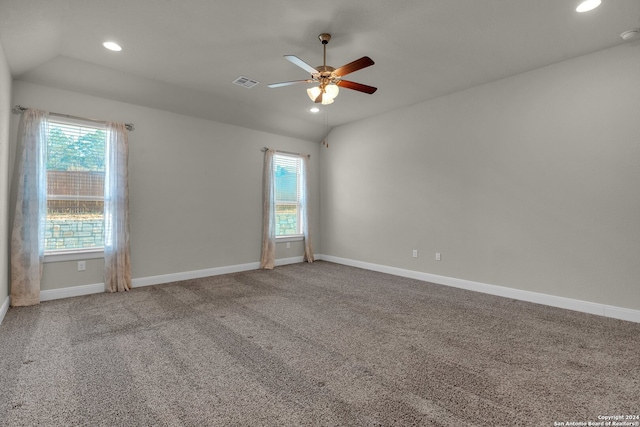 empty room featuring carpet flooring, a wealth of natural light, lofted ceiling, and ceiling fan