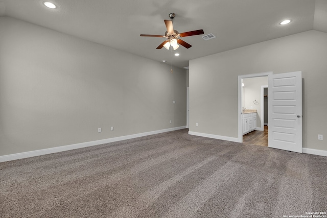 unfurnished bedroom with connected bathroom, ceiling fan, light carpet, and vaulted ceiling