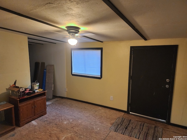 bedroom featuring ceiling fan and a textured ceiling