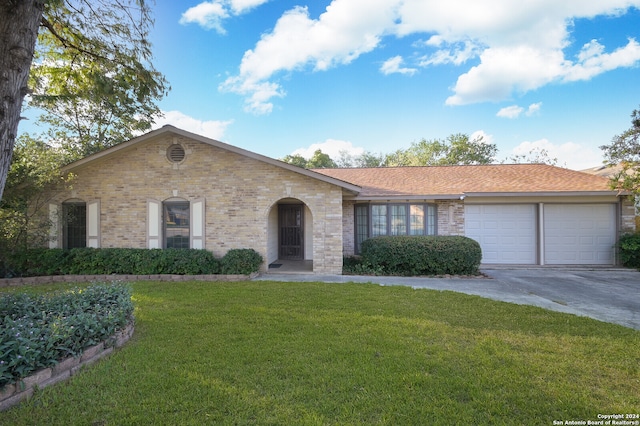 single story home featuring a garage and a front yard