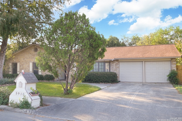 single story home with a garage and a front lawn