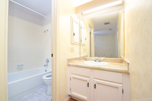 full bathroom featuring tile patterned floors, vanity, toilet, and tiled shower / bath combo